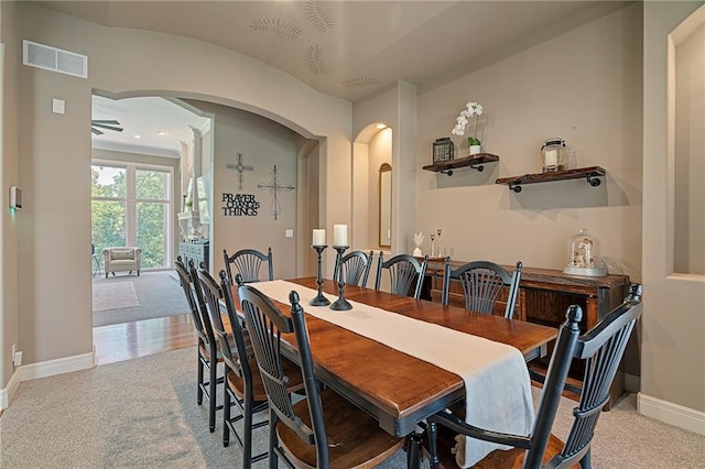8709 Pine St, Lenexa, KS 66220 - dining room with arched walkways, light colored carpet, and a ceiling fan