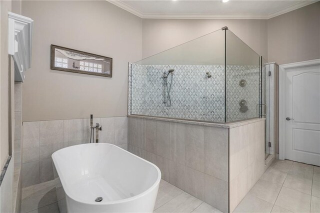8709 Pine St, Lenexa, KS 66220 - bathroom featuring a shower stall, a freestanding bath, tile walls, tile patterned flooring, and crown molding