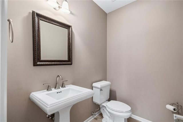 8709 Pine St, Lenexa, KS 66220 - bathroom with toilet and baseboards