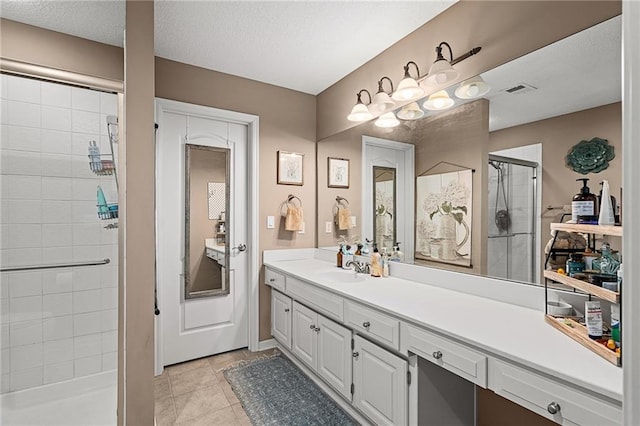 8709 Pine St, Lenexa, KS 66220 - bathroom with a stall shower, vanity, tile patterned flooring, and a textured ceiling