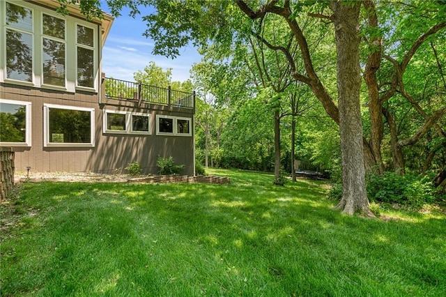 8709 Pine St, Lenexa, KS 66220 - view of grassy yard featuring a balcony
