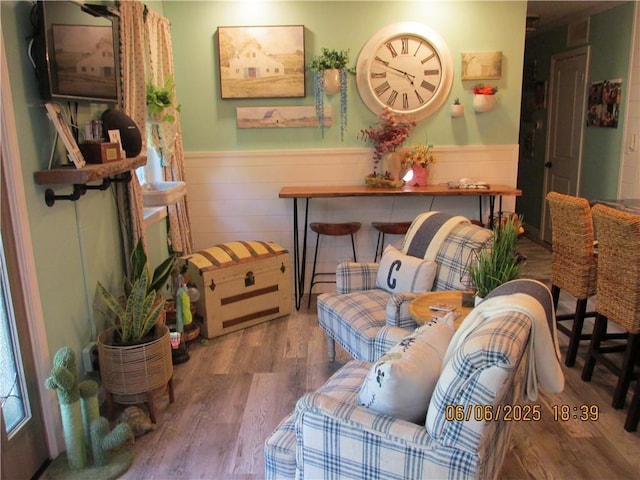 112 Spruce St, Garden City, MO 64747 - sitting room featuring wainscoting and wood finished floors