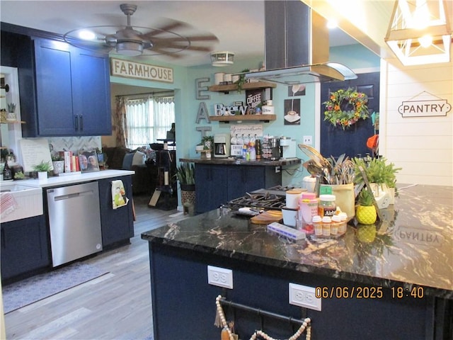 112 Spruce St, Garden City, MO 64747 - kitchen featuring stainless steel dishwasher, island exhaust hood, ceiling fan, light wood finished floors, and blue cabinetry