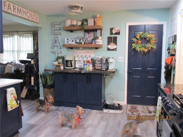 112 Spruce St, Garden City, MO 64747 - kitchen featuring black range with gas cooktop, wood finished floors, and baseboards
