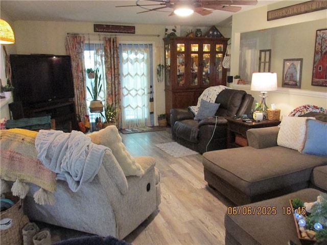 112 Spruce St, Garden City, MO 64747 - living area with a ceiling fan and wood finished floors