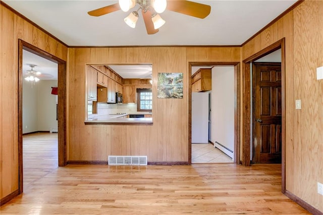 3437 Shrine Park Rd, Leavenworth, KS 66048 - kitchen with a baseboard radiator, freestanding refrigerator, a ceiling fan, light wood finished floors, and ornamental molding
