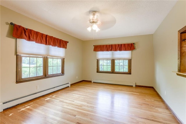 3437 Shrine Park Rd, Leavenworth, KS 66048 - empty room featuring a baseboard radiator, baseboard heating, wood finished floors, ceiling fan, and a textured ceiling