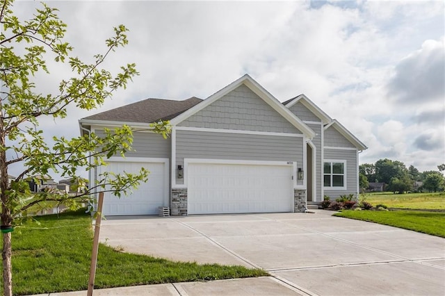 18722 W 169th Ter, Olathe, KS 66062 - craftsman inspired home featuring a garage, concrete driveway, a front yard, and stone siding