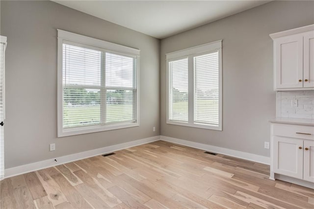 18722 W 169th Ter, Olathe, KS 66062 - unfurnished dining area with light wood-style flooring and baseboards