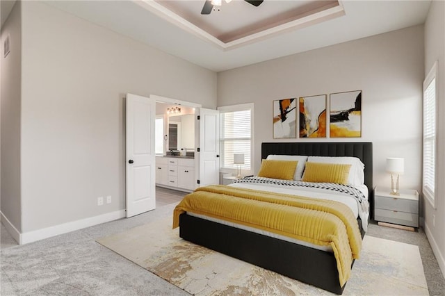 18722 W 169th Ter, Olathe, KS 66062 - bedroom featuring light carpet, baseboards, a tray ceiling, and ensuite bath