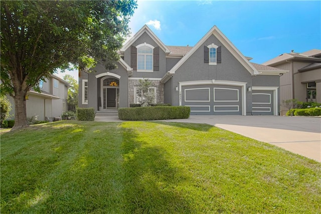 16321 Nieman Rd, Overland Park, KS 66062 - view of front of property with stucco siding, stone siding, concrete driveway, and a front lawn