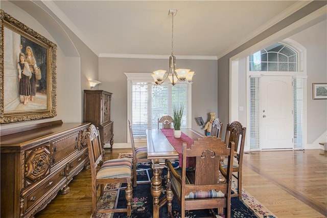 16321 Nieman Rd, Overland Park, KS 66062 - dining room with a chandelier, wood finished floors, and ornamental molding