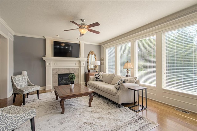 16321 Nieman Rd, Overland Park, KS 66062 - living area featuring a ceiling fan, crown molding, plenty of natural light, a fireplace, and a textured ceiling