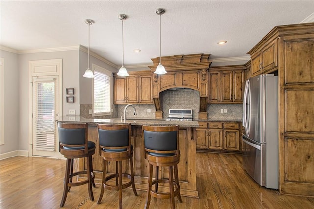 16321 Nieman Rd, Overland Park, KS 66062 - kitchen featuring freestanding refrigerator, stove, brown cabinets, dark wood-style flooring, and ornamental molding