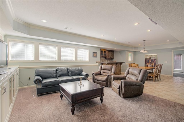 16321 Nieman Rd, Overland Park, KS 66062 - living room with a raised ceiling, a textured ceiling, crown molding, healthy amount of natural light, and recessed lighting
