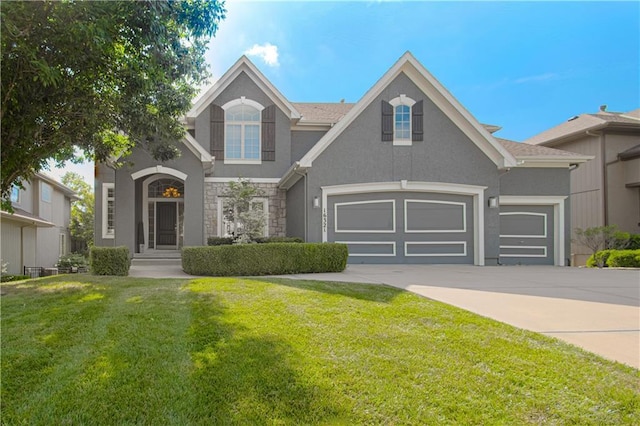16321 Nieman Rd, Overland Park, KS 66062 - view of front facade featuring concrete driveway, a front yard, stucco siding, and stone siding