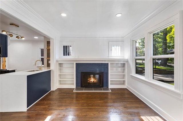 17 E 65th Ter, Kansas City, MO 64113 - unfurnished living room featuring ornamental molding, wood finished floors, a glass covered fireplace, and recessed lighting
