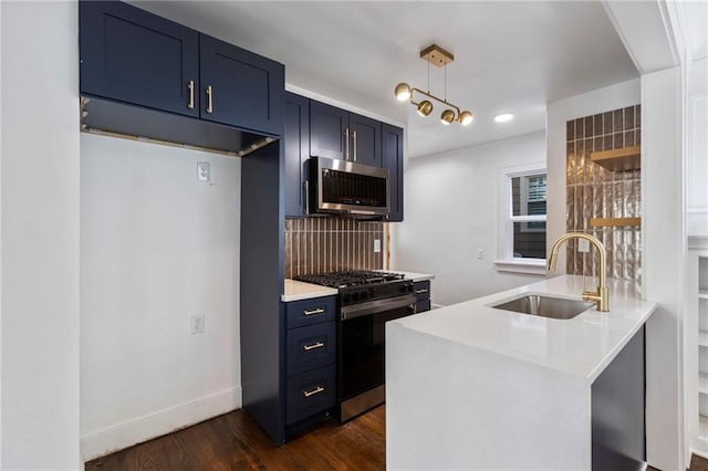 17 E 65th Ter, Kansas City, MO 64113 - kitchen featuring stainless steel microwave, range with gas stovetop, blue cabinetry, light countertops, and recessed lighting