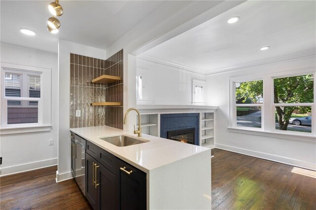 17 E 65th Ter, Kansas City, MO 64113 - kitchen with dishwasher, open shelves, light countertops, a glass covered fireplace, and dark wood-style floors