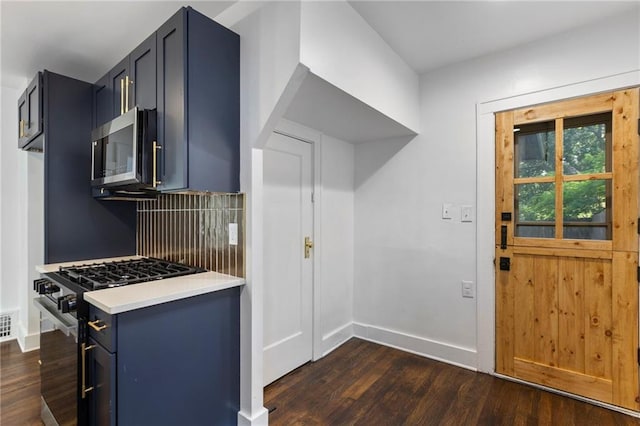 17 E 65th Ter, Kansas City, MO 64113 - kitchen featuring stainless steel appliances, dark wood-type flooring, light countertops, and decorative backsplash