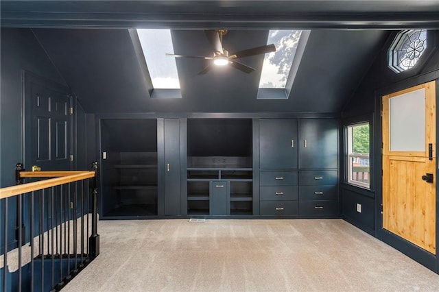 17 E 65th Ter, Kansas City, MO 64113 - empty room with lofted ceiling, carpet, a skylight, and ceiling fan