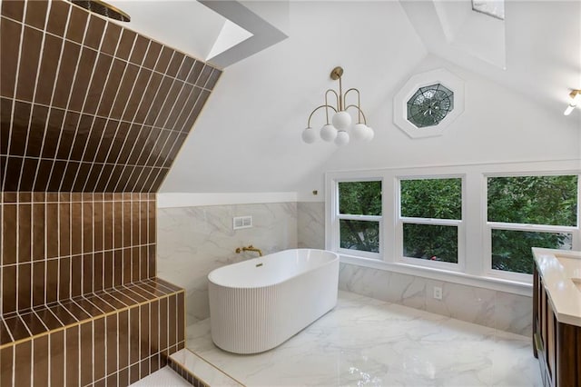 17 E 65th Ter, Kansas City, MO 64113 - full bath featuring tile walls, a freestanding tub, marble tiled floors, vanity, and lofted ceiling