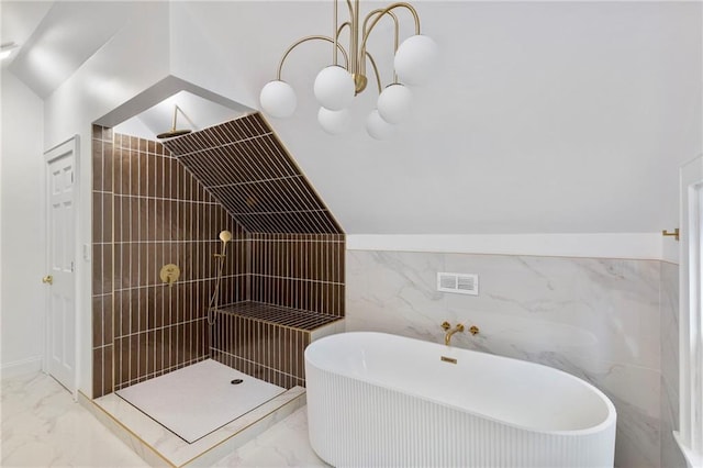 17 E 65th Ter, Kansas City, MO 64113 - full bath featuring tile walls, marble finish flooring, tiled shower, vaulted ceiling, and a soaking tub