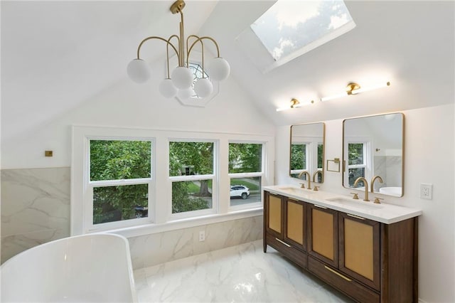 17 E 65th Ter, Kansas City, MO 64113 - bathroom featuring marble tiled floors, a skylight, a freestanding tub, a chandelier, and double vanity