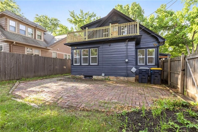 17 E 65th Ter, Kansas City, MO 64113 - back of property featuring a patio area and a fenced backyard
