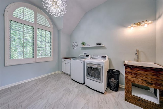 14911 Outlook Ln, Overland Park, KS 66223 - laundry area featuring cabinet space, washer and clothes dryer, and a chandelier