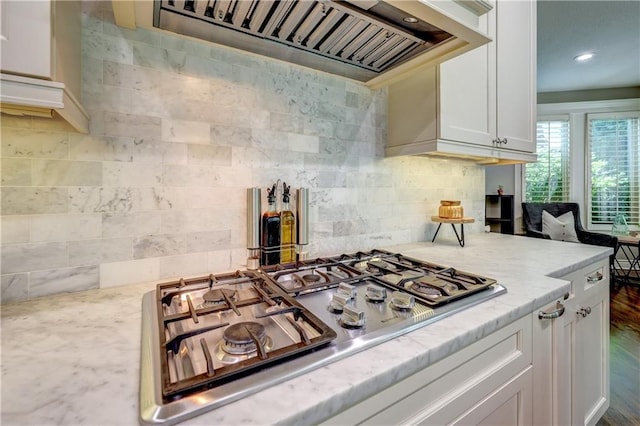 14911 Outlook Ln, Overland Park, KS 66223 - kitchen featuring stainless steel gas stovetop, custom range hood, decorative backsplash, white cabinetry, and recessed lighting
