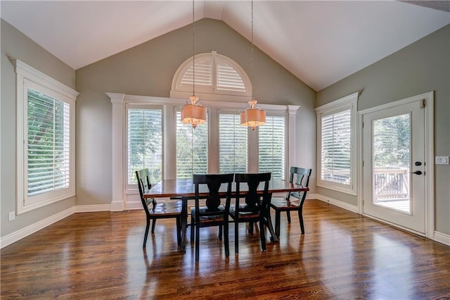 14911 Outlook Ln, Overland Park, KS 66223 - dining room featuring dark wood-style flooring, vaulted ceiling, and plenty of natural light