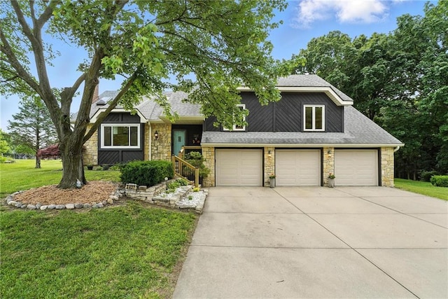 3437 N Wabash Ave, Kansas City, MO 64116 - view of front of house with stone siding, concrete driveway, a front lawn, roof with shingles, and an attached garage