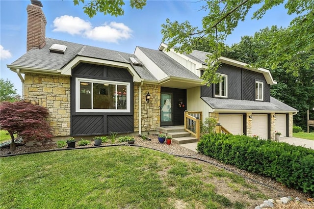 3437 N Wabash Ave, Kansas City, MO 64116 - view of front of home with stone siding, a garage, a chimney, and a front lawn