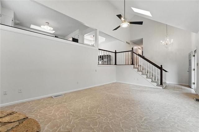 3437 N Wabash Ave, Kansas City, MO 64116 - unfurnished living room with a skylight, a chandelier, stairs, high vaulted ceiling, and ceiling fan
