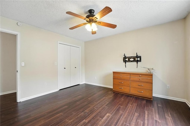 3437 N Wabash Ave, Kansas City, MO 64116 - unfurnished bedroom with dark wood-style floors, a closet, ceiling fan, and a textured ceiling