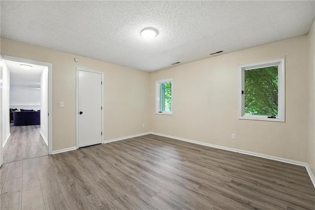 3437 N Wabash Ave, Kansas City, MO 64116 - unfurnished bedroom with wood finished floors and a textured ceiling