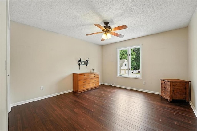 3437 N Wabash Ave, Kansas City, MO 64116 - unfurnished bedroom with dark wood-style floors, a textured ceiling, and ceiling fan