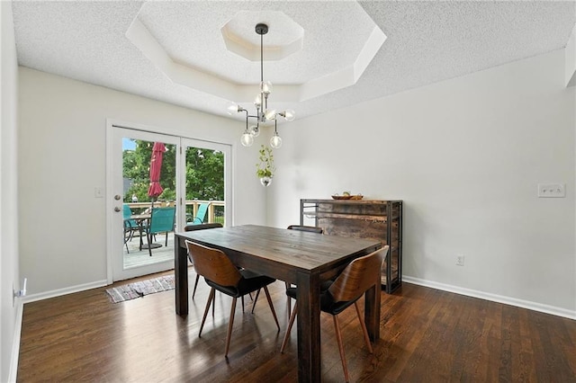 3437 N Wabash Ave, Kansas City, MO 64116 - dining area featuring wood finished floors, a tray ceiling, and a textured ceiling