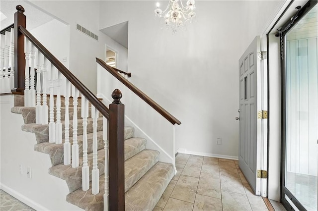 3437 N Wabash Ave, Kansas City, MO 64116 - entryway with stairs, a high ceiling, and a chandelier