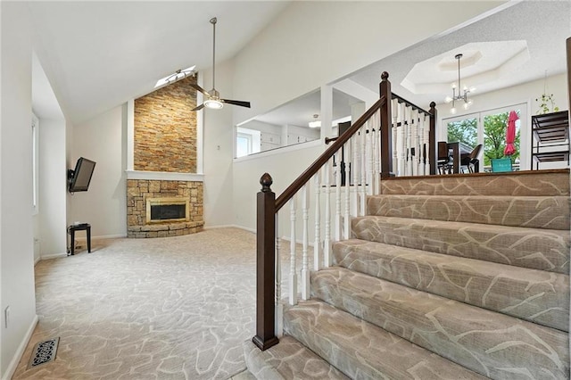 3437 N Wabash Ave, Kansas City, MO 64116 - stairway with carpet flooring, a chandelier, plenty of natural light, a fireplace, and high vaulted ceiling