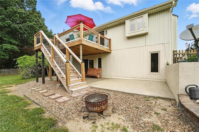 3437 N Wabash Ave, Kansas City, MO 64116 - back of house featuring an outdoor fire pit, a wooden deck, stairs, and a patio area