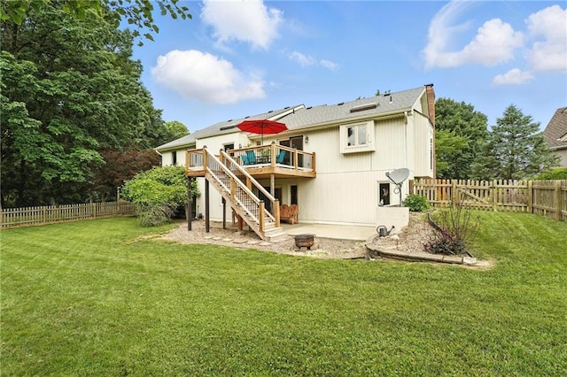 3437 N Wabash Ave, Kansas City, MO 64116 - rear view of property featuring a deck, stairs, a fenced backyard, and a chimney