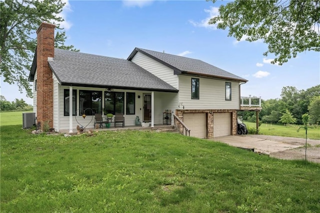 19109 Quinn Rd, Trimble, MO 64492 - rear view of property featuring a chimney, central AC, an attached garage, driveway, and a lawn