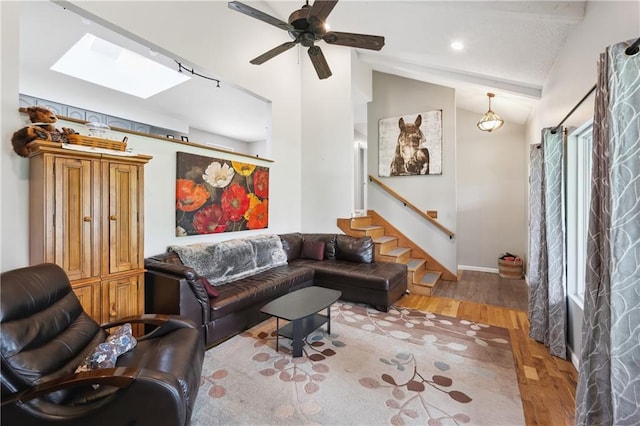 19109 Quinn Rd, Trimble, MO 64492 - living room with lofted ceiling, wood finished floors, a skylight, stairway, and ceiling fan