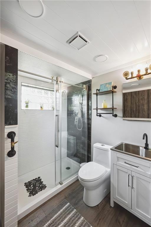 19109 Quinn Rd, Trimble, MO 64492 - bathroom with vanity, toilet, a shower stall, and wood finished floors