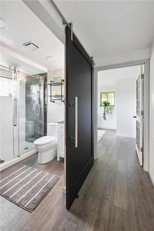 19109 Quinn Rd, Trimble, MO 64492 - full bathroom featuring toilet, wood finished floors, and a shower stall