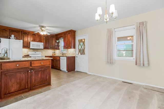 1310 N Leeview Cir, Olathe, KS 66061 - kitchen with white appliances, ceiling fan, a chandelier, pendant lighting, and backsplash