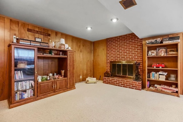 1310 N Leeview Cir, Olathe, KS 66061 - living area featuring carpet floors, a brick fireplace, wooden walls, and recessed lighting