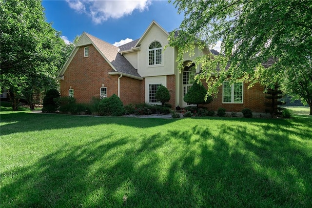 6501 N National Dr, Parkville, MO 64152 - traditional-style house featuring a front lawn, brick siding, and stucco siding